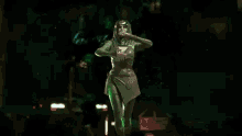 a person is surrounded by green lights in a dark room