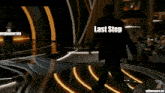 a man in a suit stands on a stage with the words last step conglomerate