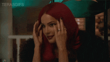 a woman with red hair is talking on a cell phone and the words terasgifs are visible in the corner