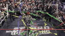 a wrestler is surrounded by ribbons in a wrestling ring that says wtv on it