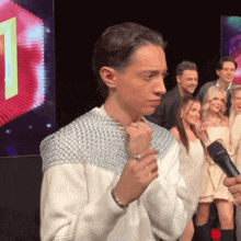 a group of people are standing in front of a screen with the number 1