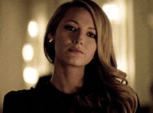 a woman with long blonde hair is wearing earrings