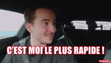 a man in a car with the words " c'est moi le plus rapide " written above him