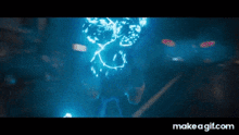 a person is standing in a dark room with a blue light coming out of them