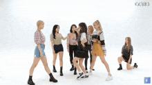 a group of girls are playing with each other and one of them is wearing a yellow skirt that says fila