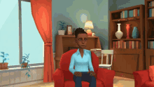 a woman in a blue shirt sits in a red chair