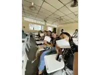 a group of women sitting in a classroom holding a certificate that says " congratulations "