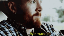 a man with a beard says we made it in a plaid shirt