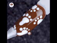 a close up of a nail with a design on it that looks like footprints