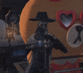 a man in a hat stands in front of a stuffed animal that has a heart on its face