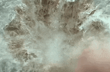 a close up of a man 's face with water coming out of it .