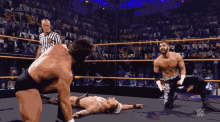 two wrestlers in a wrestling ring with a referee and the words # 205live on the screen