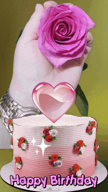 a woman holds a pink rose in front of a birthday cake that says happy birthday