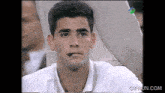 a close up of a man 's face with a gifrun.com watermark on the bottom