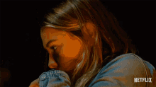 a close up of a woman 's face with a netflix logo on the bottom