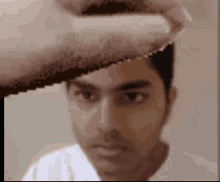 a blurry picture of a man 's face with a towel on it
