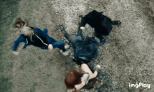 a group of people are standing on top of each other in a field .