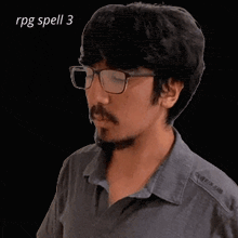 a man with glasses and a beard is playing a video game with the words rpg spell 3 above him