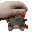 a person is holding a stuffed animal with a red scarf around its head .