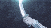 a person is holding a sword with a light coming out of it .