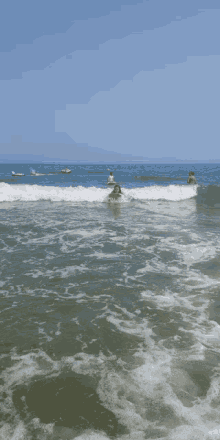 a person is swimming in the ocean with a jet ski behind them