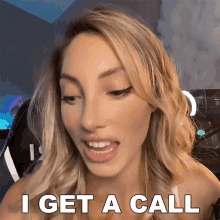 a blonde woman says i get a call in front of a computer