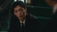 a man in a suit and tie is smiling with the website dryedmangoes.com visible in the corner