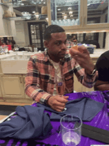 a man sitting at a table with a glass of wine