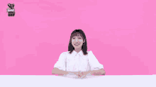a girl in a white shirt is standing in front of a pink background with the words fresh 10 day written on it