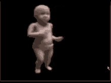 a baby is dancing on a black background .