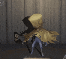 a person in a yellow cape is standing in a room