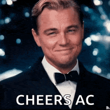 a man in a suit and bow tie is smiling with the words cheers ac written below him