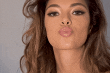 a close up of a woman 's face making a funny face