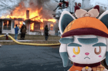 a stuffed animal in front of a burning house with the number 18 in the background