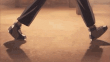 a close up of a person 's feet walking on a brown floor .