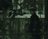 a man with a mohawk looks at the camera with a serious look on his face