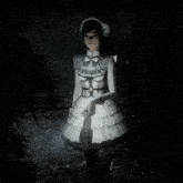 a girl in a white dress stands in the dark holding a flashlight