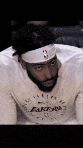 a man with a beard wearing a headband with the nba logo on it