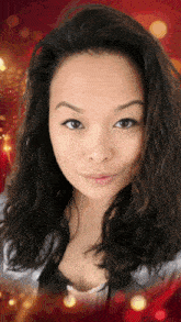 a woman with long dark hair is smiling for the camera