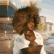 a woman with a choker around her neck has a large afro
