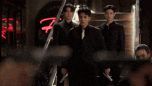 a man is pointing a gun at another man in a dark room