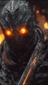 a close up of a demon with fire coming out of his eyes .
