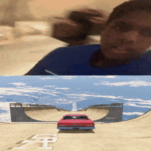 a red car is driving down a ramp with the letter f on the ground
