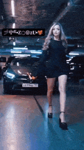 a woman in a black dress is walking in front of a car in a parking lot .