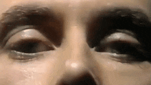 a close up of a person 's eyes with makeup on their face .