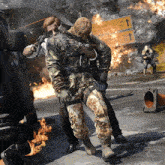 two soldiers are fighting in front of a sign that says i love you