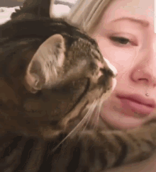 a close up of a woman 's face with a cat on it
