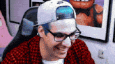 a man wearing glasses and a nike hat