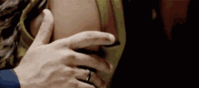 a man is touching a woman 's back with his hand .