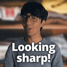 a man wearing glasses says looking sharp in white letters